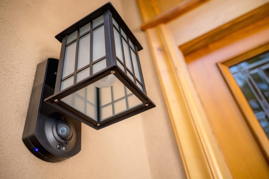 Integrated home security system with porch light camera and indoor cameras