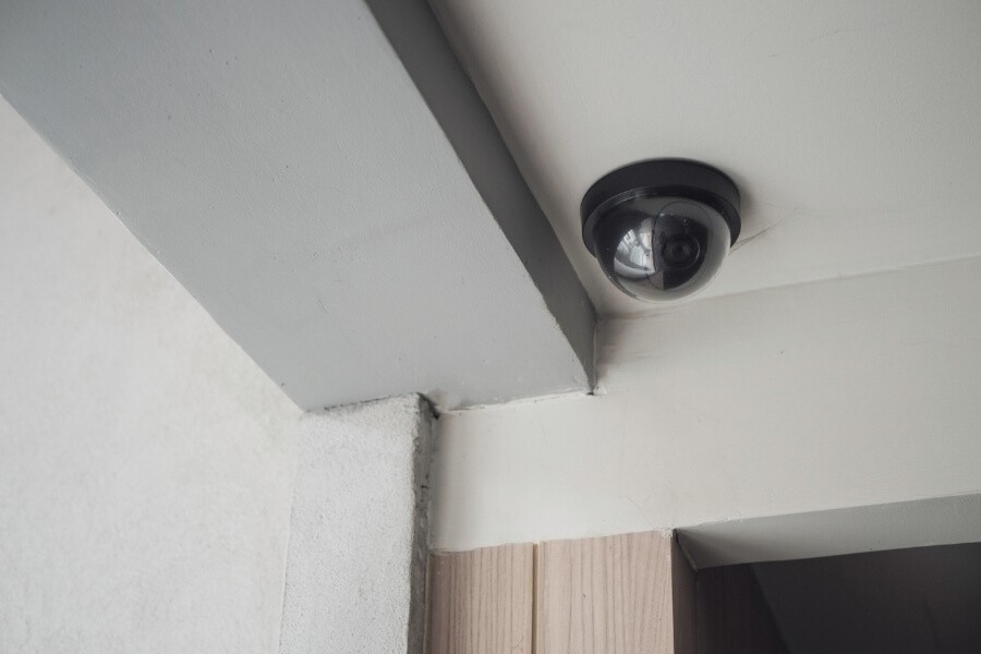 Home security camera installed out of reach with remote monitoring